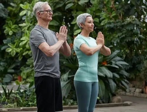 Older man and woman practising yoga