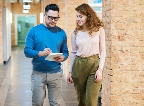 man talking with woman in a corridor